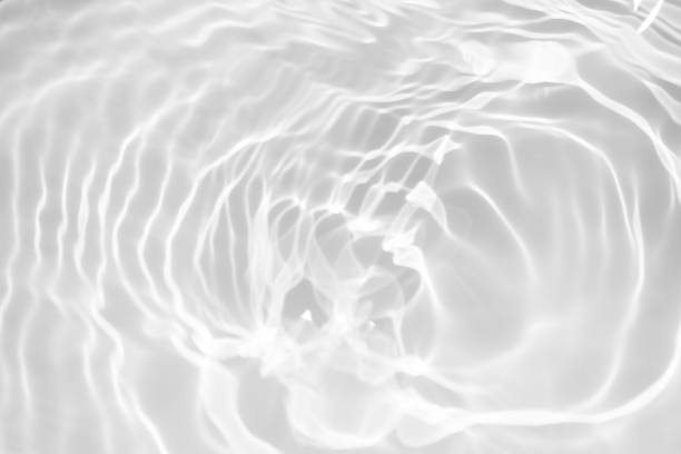 istock White water with ripples on the surface. Defocus blurred transparent white colored clear calm water surface texture with splashes and bubbles. Water waves with shining pattern texture background. 1923583229