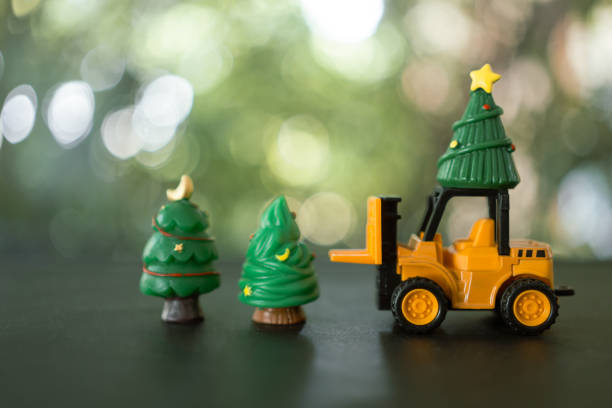 istock A toy forklift driver transport christmas trees at Christmas day. 1923611502