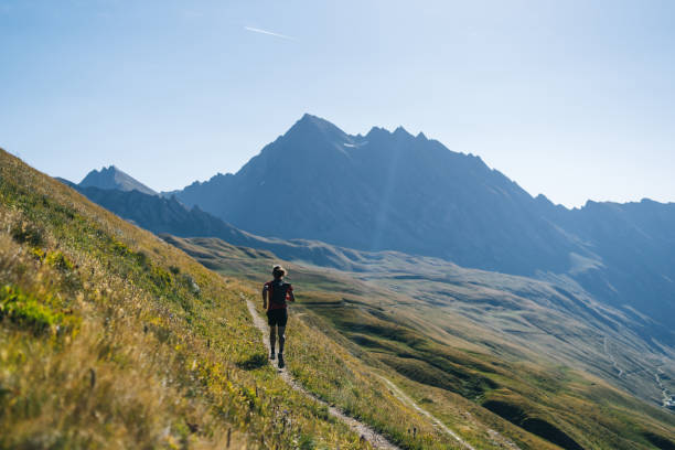 istock Trail runner bounds along mountain trail 1923628323
