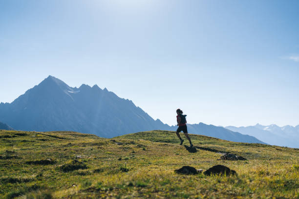 istock Trail runner bounds along mountain trail 1923630478