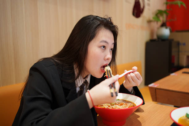istock Young woman enjoying pasta 1923632578