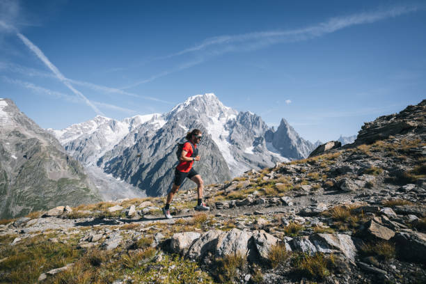 istock Trail runner bounds along mountain trail 1923635686