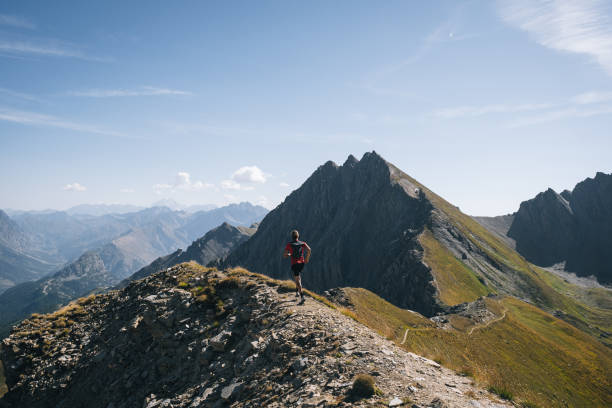 istock Trail runner bounds along mountain trail 1923638260