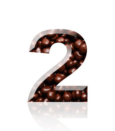 Close-up of three-dimensional chocolate number 2 on white background.