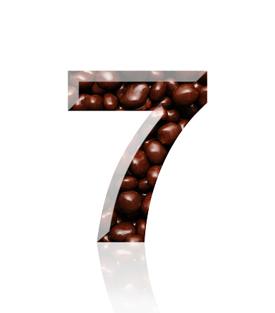 Close-up of three-dimensional chocolate number 7 on white background.