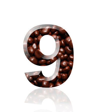Close-up of three-dimensional chocolate number 9 on white background.