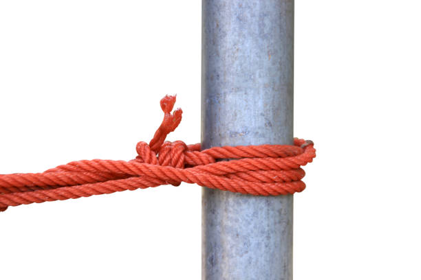 Knot made of bold red rope isolated on dark background