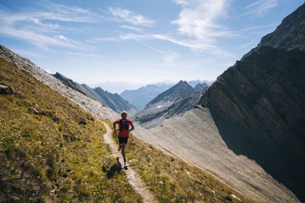 istock Trail runner bounds along mountain trail 1923644698