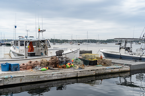 Boothbay Harbor, Maine - July 13, 2021: Lobster boats with traps docked in Boothbay Harbor, Maine