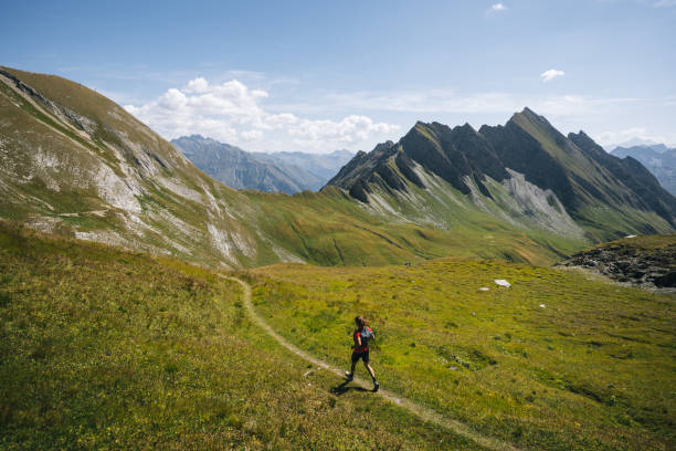 istock Trail runner bounds along mountain trail 1923649409