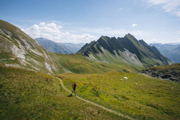 istock Trail runner bounds along mountain trail 1923649412