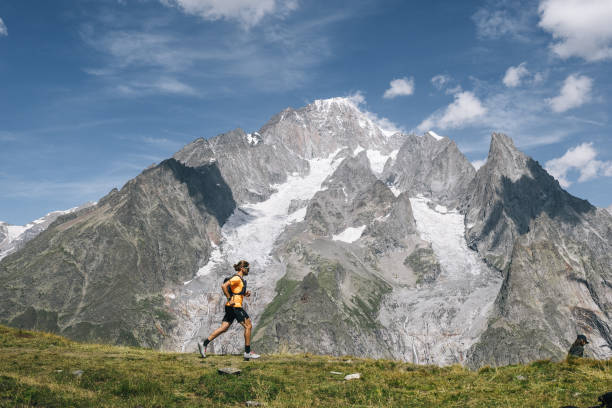 istock Trail runner bounds along mountain trail 1923652978
