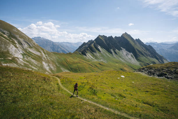 istock Trail runner bounds along mountain trail 1923652979