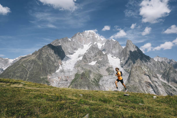 istock Trail runner bounds along mountain trail 1923652980