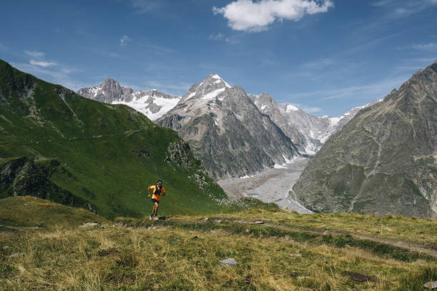 istock Trail runner bounds along mountain trail 1923656072