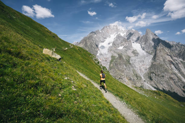 istock Trail runner bounds along mountain trail 1923659188