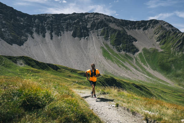 istock Trail runner bounds along mountain trail 1923663388