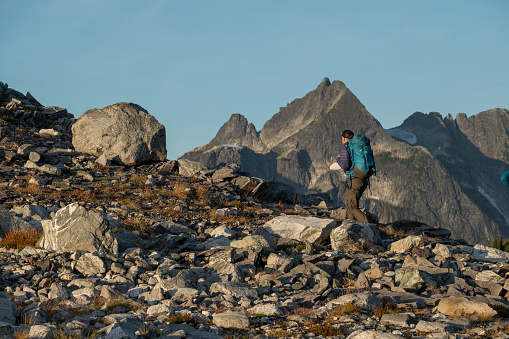 Backpacker explores mountain ridge in alpine environment