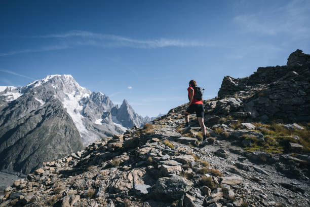 istock Trail runner bounds along mountain trail 1923695923