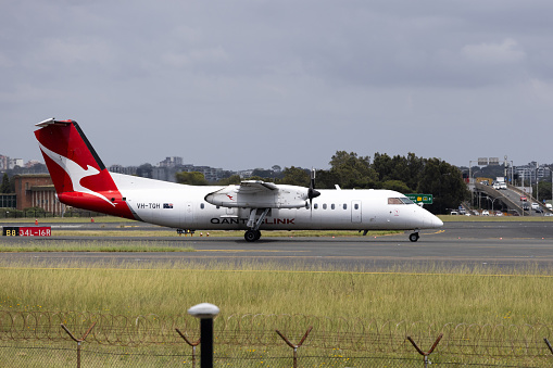 Sydney, Australia - December 17, 2023: Qantas Link De Havilland Canada Dash 8 at Sydney Airport. Registration VH-TQH.