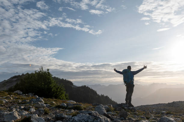 istock Backpacker explores mountain ridge at sunrise 1923696651