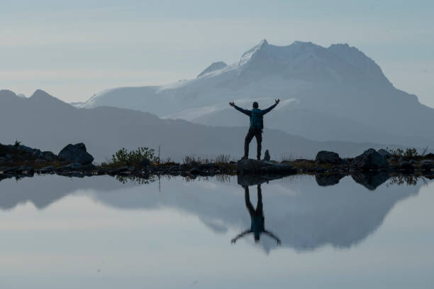 istock Backpacker pauses on mountain lakeshore 1923697478