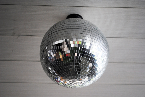 Disco mirror ball is hanging on the ceiling.