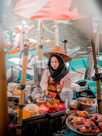 Hat Yai, Thailand- December 15, 2023: A Hijab Woman Preparing Meal at Khlong Hae Floating Market. Visit Thailand.