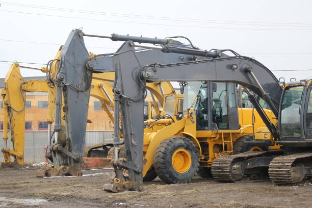 istock Several heavy construction vehicles, including excavators, diggers, earthmovers, and bulldozers 1923855752