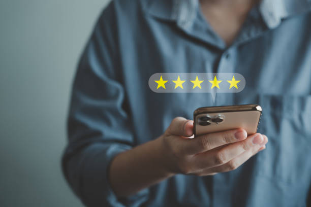 istock Customer using mobile smartphone for giving satisfaction score with five star excellent experience. 1923859917