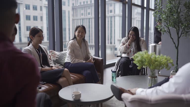 Diversify Asian seminar participants casual chat after successful conference event at lounge