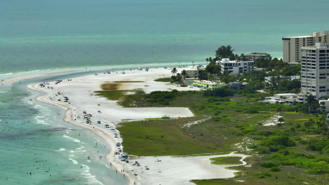 Hotel buildings in front of famous Siesta Key beach with soft white sand in Sarasota, USA on summer sunny day. Popular vacation spot in warm Florida