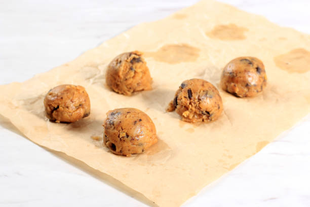 istock Scooped Raw Chocochip Cookie Dough Above Marble Table. Baking Step by Step. Cookie Dough Ready to Bake 1923931249