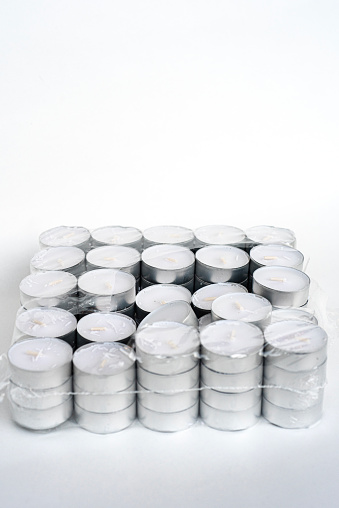 unpacked box of white tealight candles