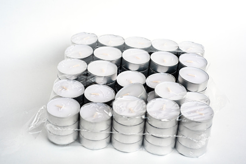 unpacked box of white tealight candles