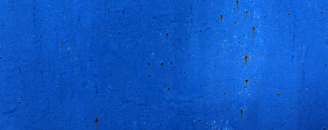 Old crack blue paint on wall surface. Abstract blue texture background