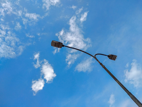 low-angle view of street lamp on blue sky background