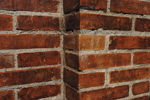 A brick is a type of construction material used to build walls, pavements and other elements in masonry construction. Properly, the term brick denotes a unit primarily composed of clay, but is now also used informally to denote units made of other materials or other chemically cured construction blocks.