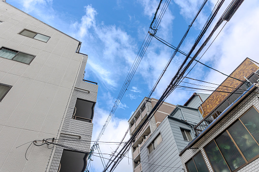 Looking up at the sky between buildings in Osaka, Japan
