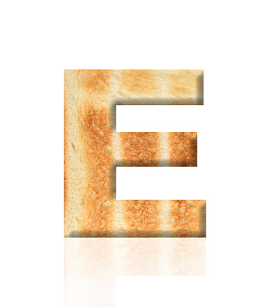 Close-up of three-dimensional toasted bread alphabet letter E on white background.