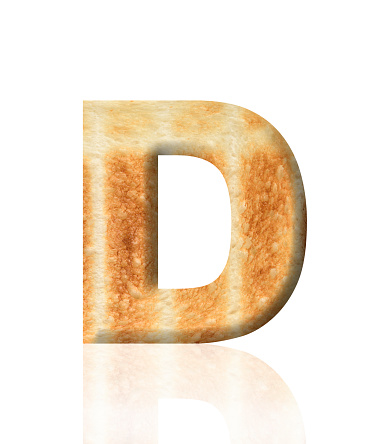 Close-up of three-dimensional toasted bread alphabet letter D on white background.