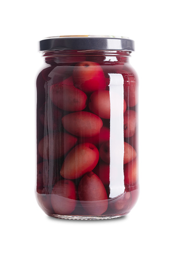 Kalamata olives, pickled whole, large and dark purple table olives, in a glass jar with screw cap. Olive variety from Kalamata region in Greece. Hand-picked ripe fruits with pit, preserved in a brine.