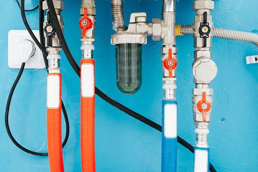Gas home construction, multi-colored pipes and regulators. Close-up of the boiler pipeline.