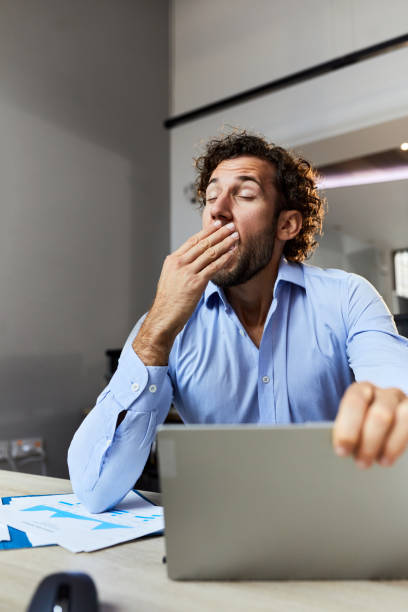 istock Exhausted businessman yawning in the office. 1924132404