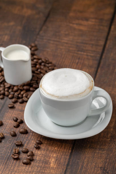 istock Cappuccino coffee in a white porcelain cup on a wooden table 1924133984