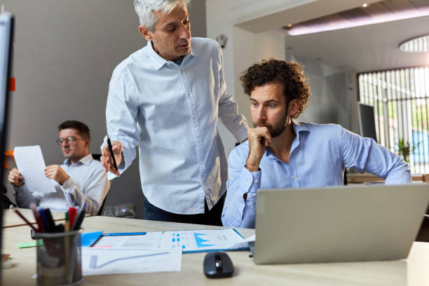 istock Male entrepreneurs going through business reports in the office. 1924136084
