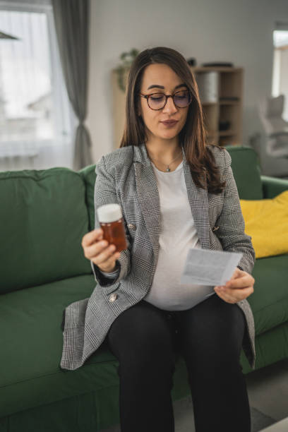 istock Expectant woman read leaflet take tablets medication or supplement 1924157182