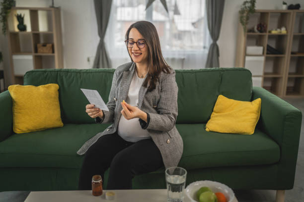 istock Expectant woman read leaflet take tablets medication or supplement 1924160339