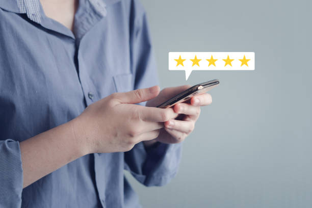 istock Customer using mobile smartphone for giving satisfaction score with five star excellent experience. 1924166139
