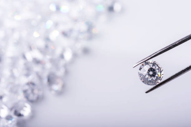 istock Diamonds of different cuts and sizes on light background with shadows. 1924188198